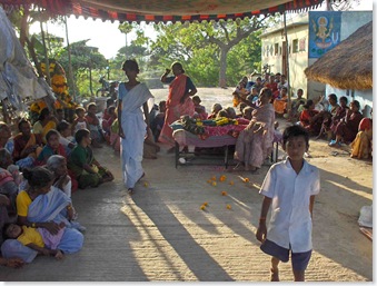 Coming into the village, under the awning is mother's body