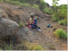 Village woman collecting plants